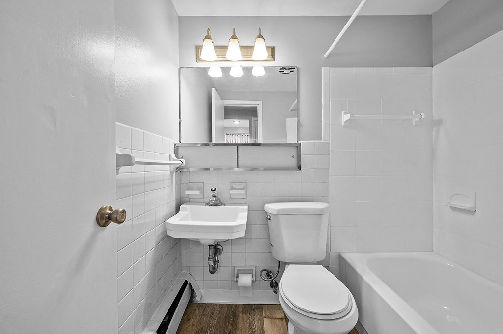 a bathroom with a sink toilet and a tub