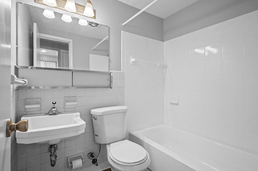 a bathroom with a sink toilet and a tub