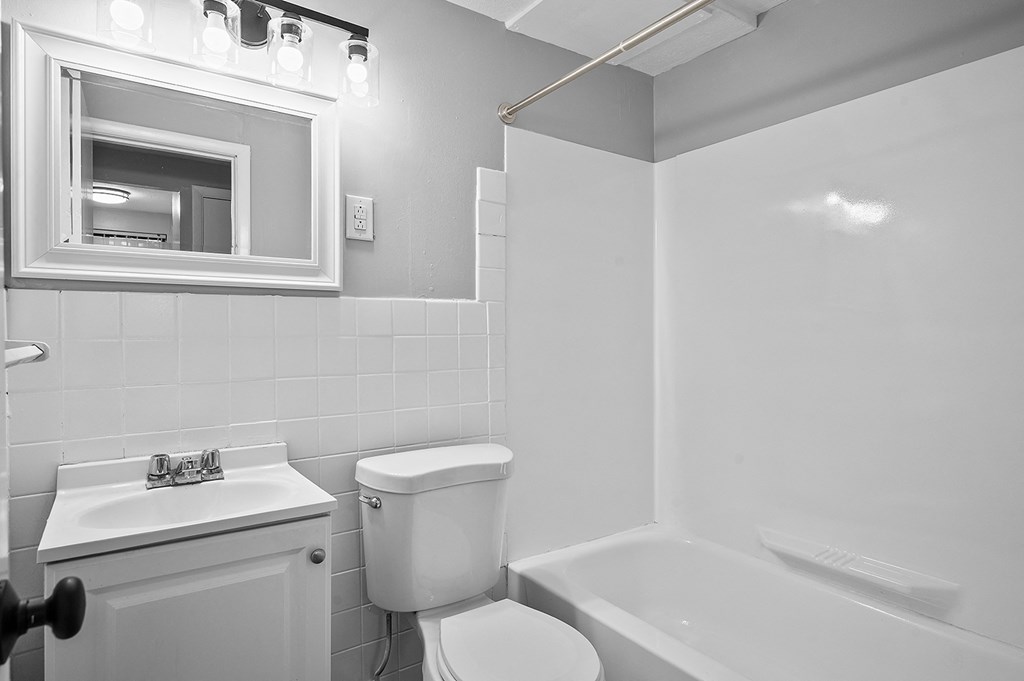 a bathroom with a sink toilet and a bath tub