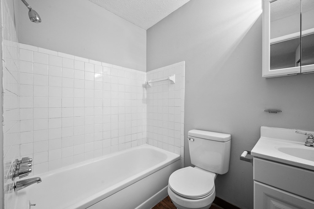 an empty bathroom with a toilet and a bath tub