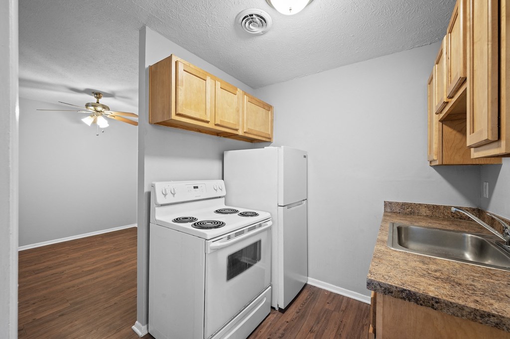 a kitchen with a stove refrigerator and a sink