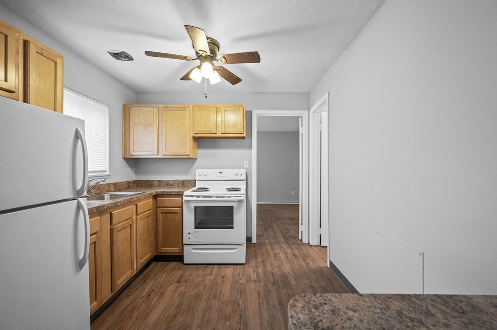 a kitchen with white appliances and wooden cabinets