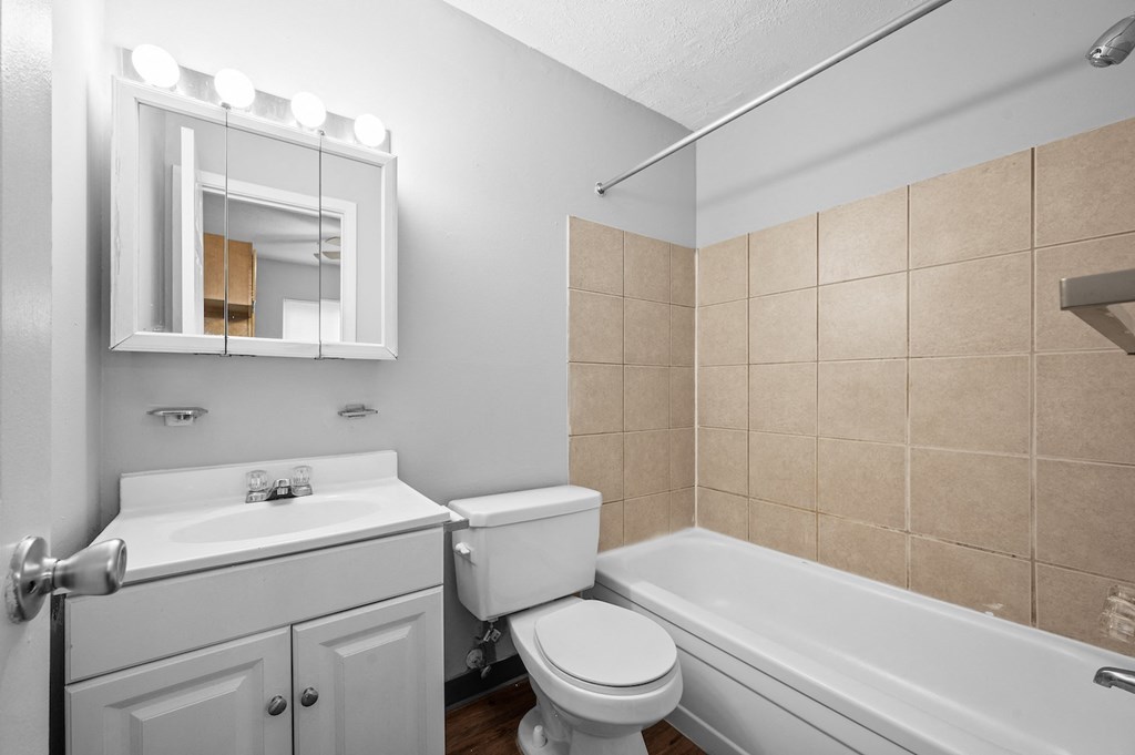 a bathroom with a sink toilet and a tub