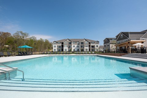 a swimming pool with apartments in the background at The Bend, Lancaster, Ohio