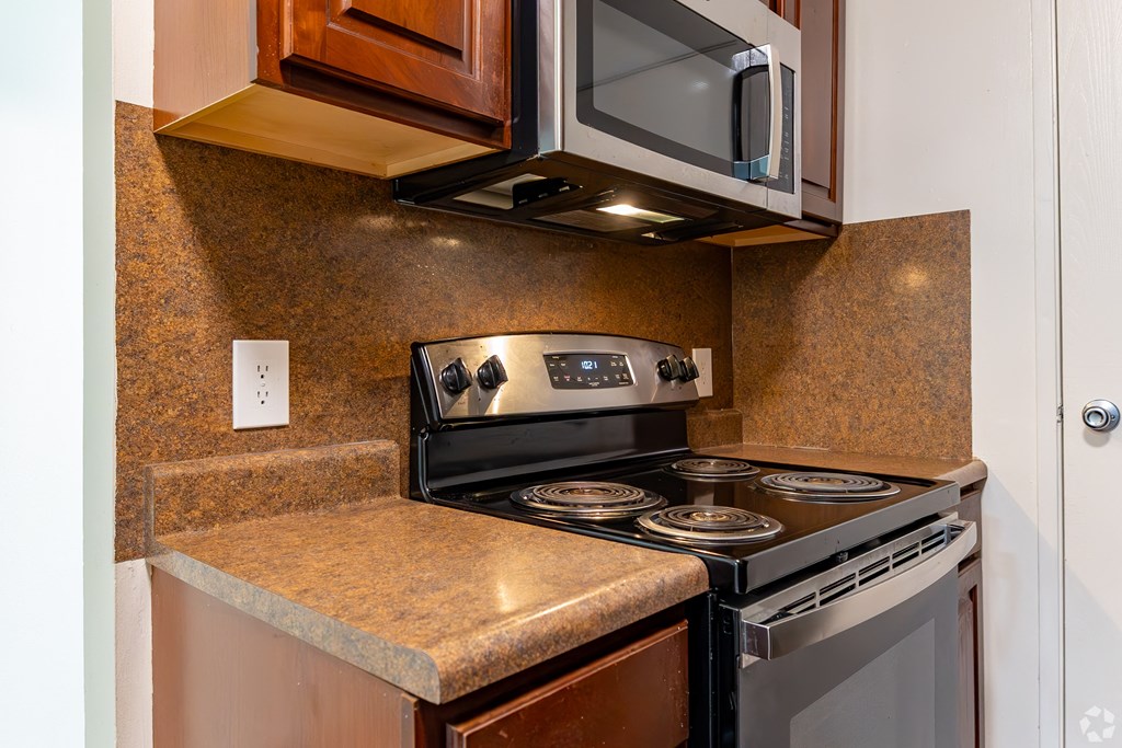 a kitchen with a stove and a microwave