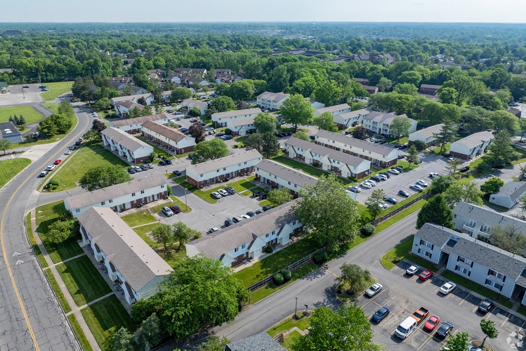 A bird's eye view of a residential area with houses and cars.