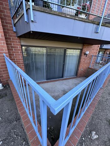 A blue metal railing on a brick building.
