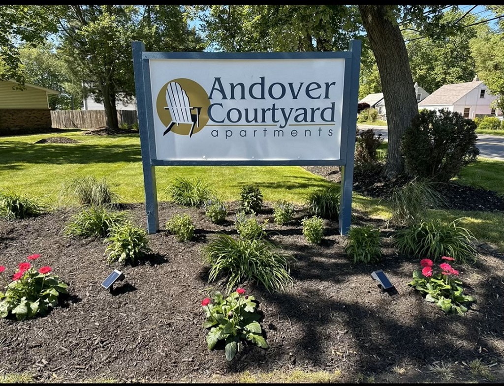 a sign operations in front of a garden