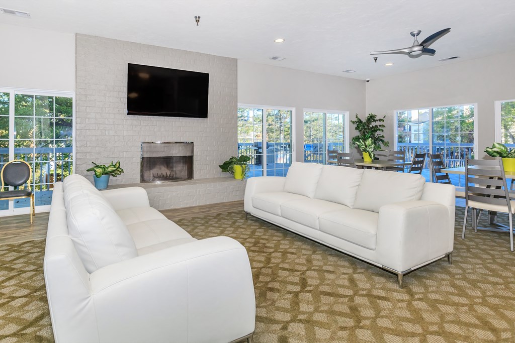 a living room with two white couches and a fireplace