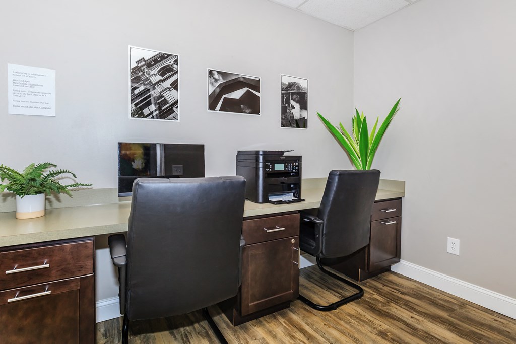 an office with two desks and two computers