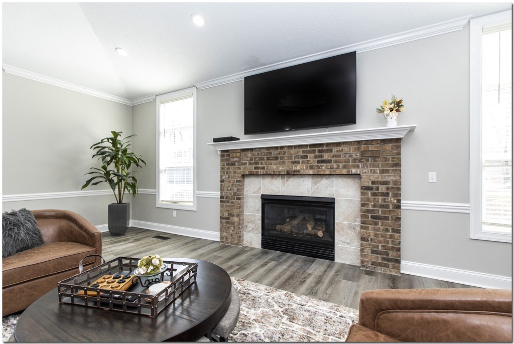 a living room with a fireplace and a tv above it