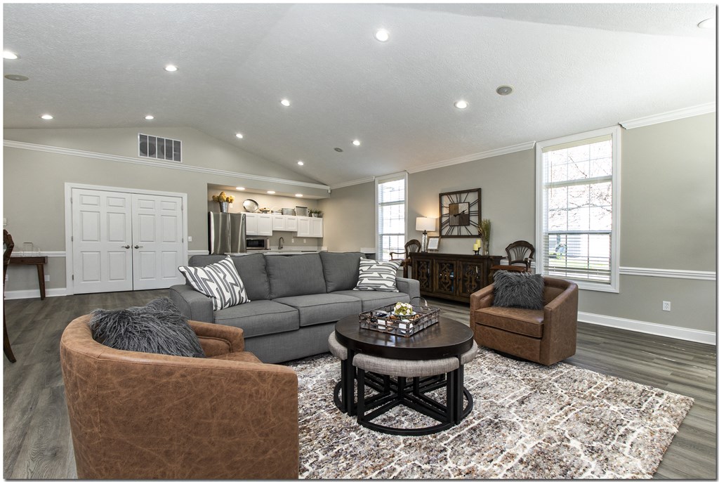 a living room with a couch and two chairs