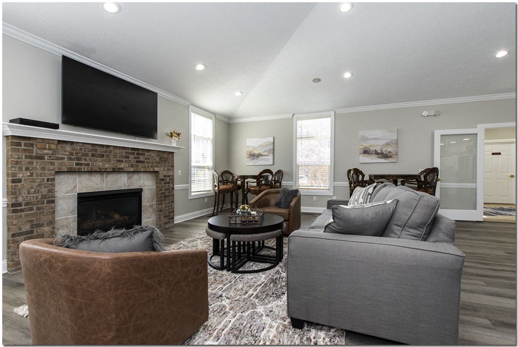 a living room with a fireplace and a tv on the wall
