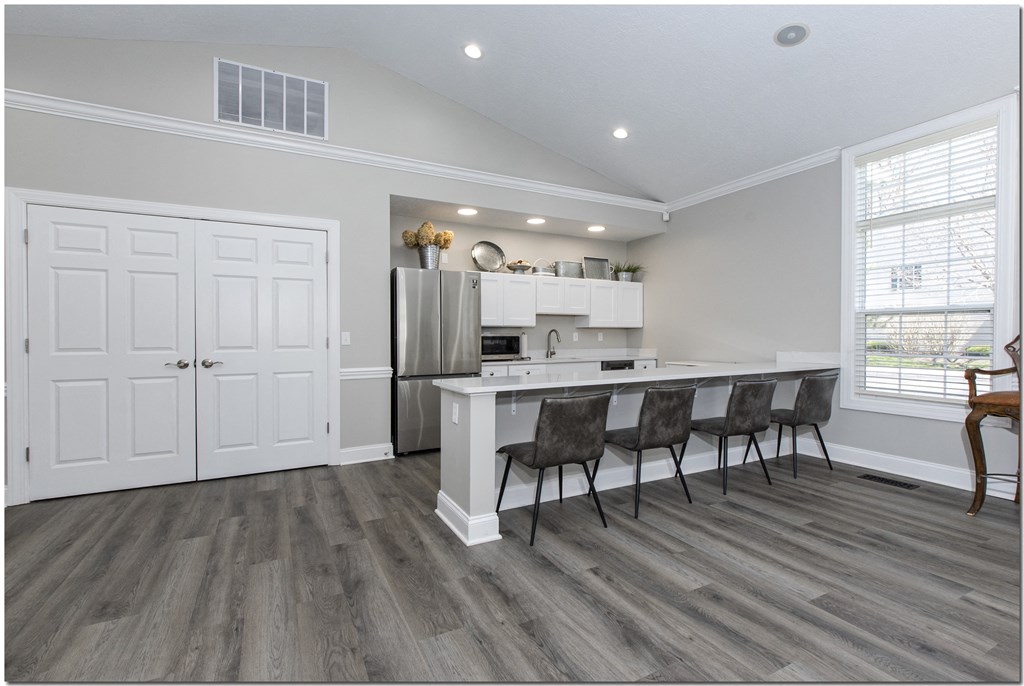 a kitchen with a refrigerator freezer next to a stove top oven
