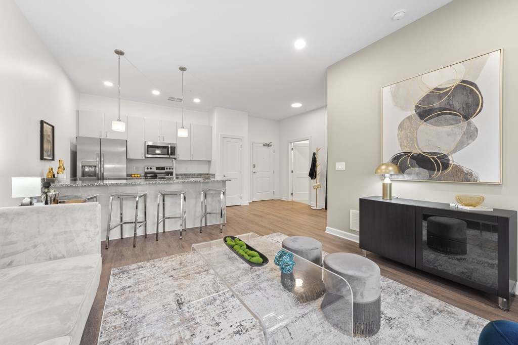 A modern kitchen with a white sofa and a grey rug. at The Lumos Apartments, Ohio