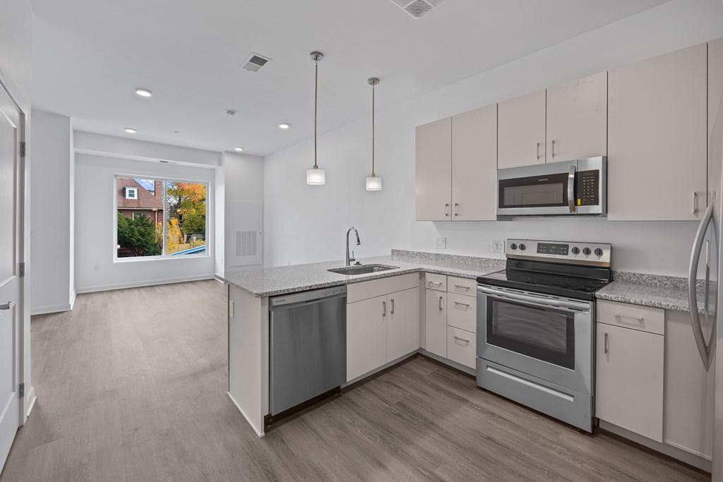 A kitchen with a stove, oven, and refrigerator. at The Lumos Apartments, Cleveland