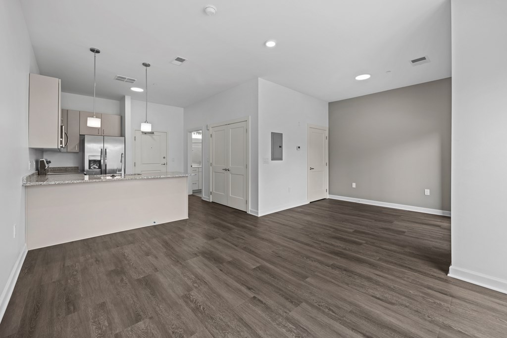 A spacious room with wood flooring and white walls. at The Lumos Apartments, Ohio
