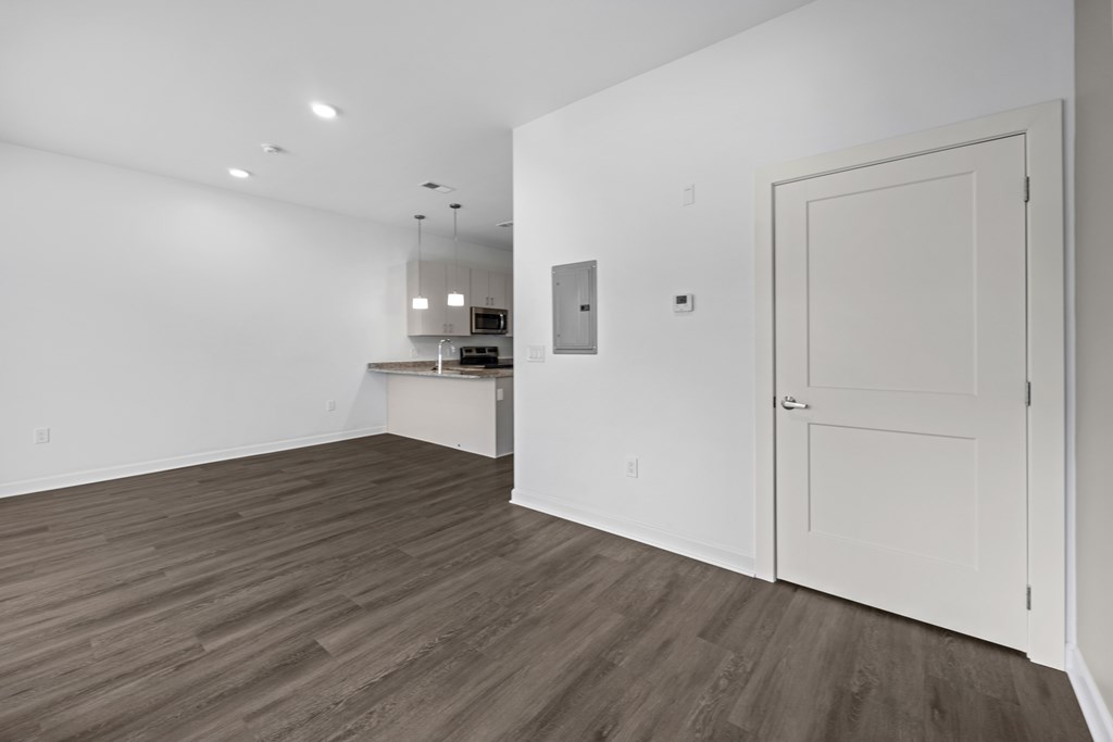 A room with a white door and a wooden floor. at The Lumos Apartments, Cleveland, Ohio