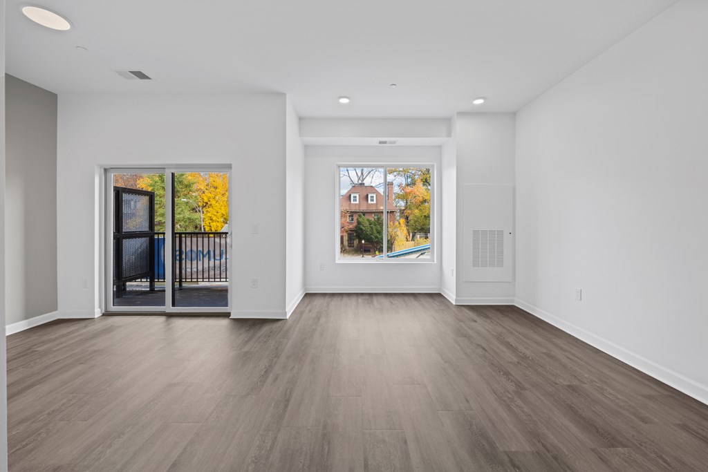 A spacious room with a view of a building through a window. at The Lumos Apartments, Cleveland, OH, 44106
