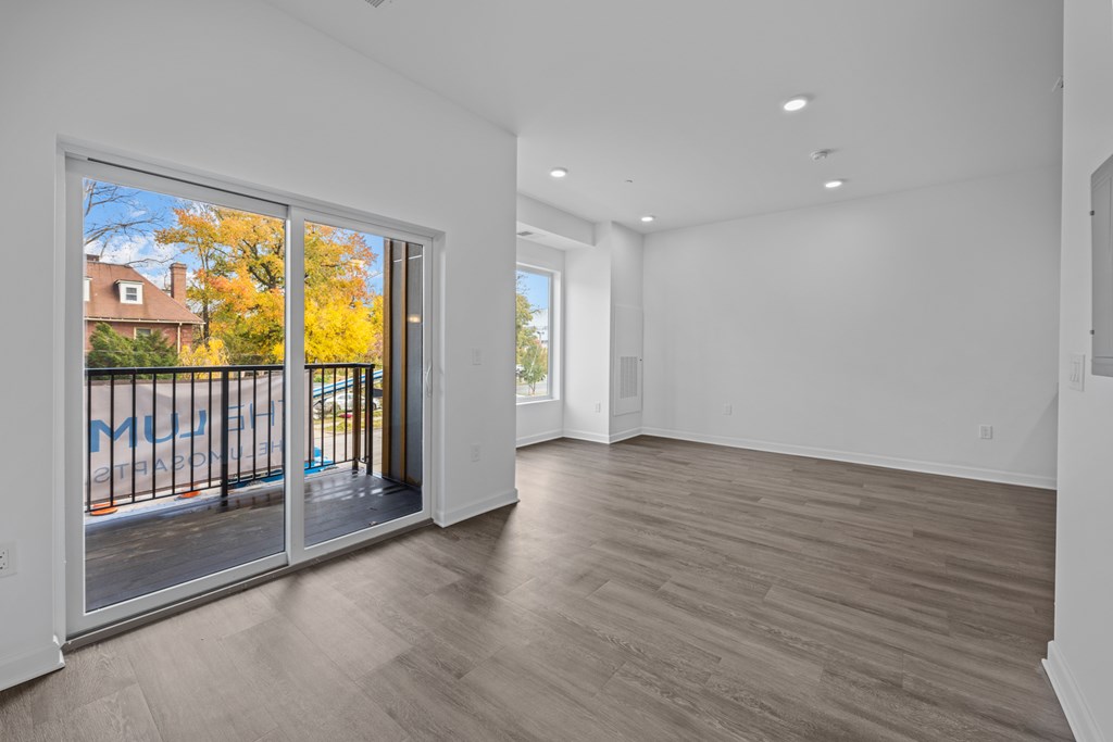 A room with a sliding glass door leading to a balcony. at The Lumos Apartments, Cleveland, Ohio