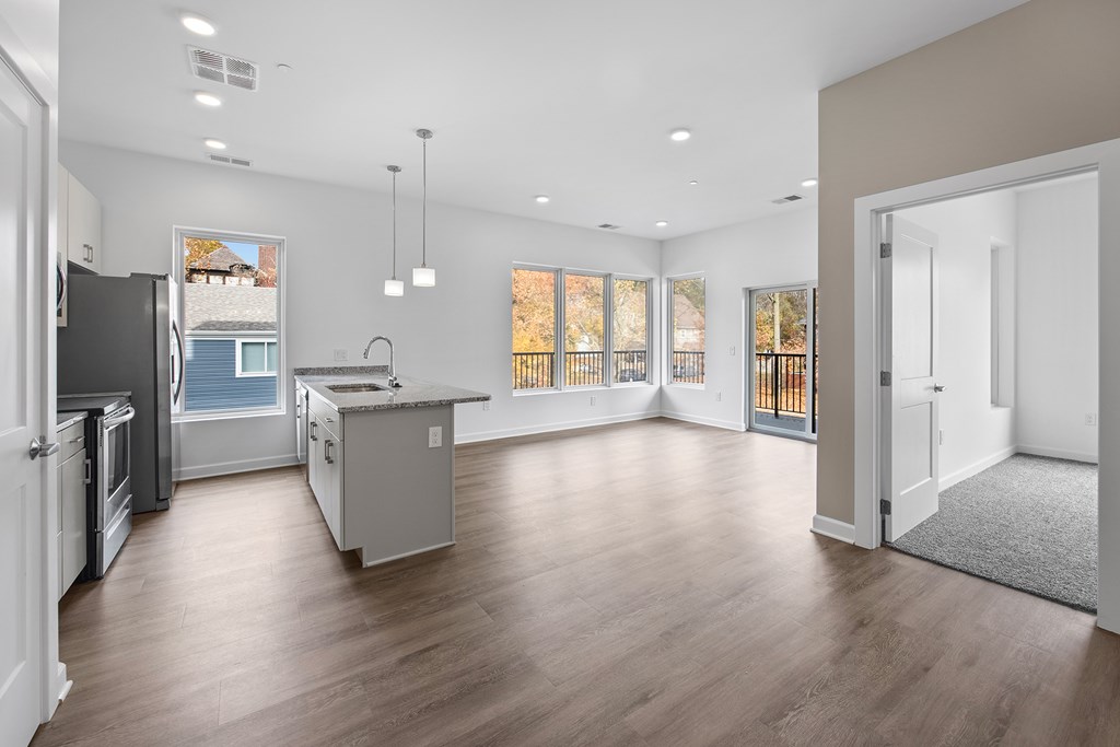 A spacious kitchen with a refrigerator, sink, and cabinets. at The Lumos Apartments, Ohio, 44106