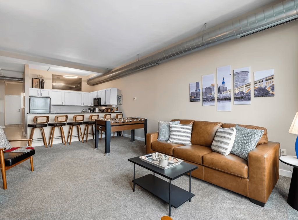 A living room with a brown couch and a coffee table.