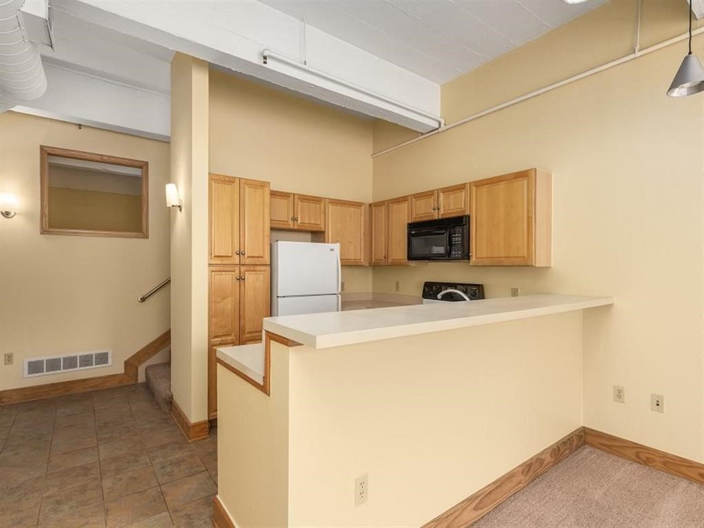 a kitchen with a counter top and a refrigerator