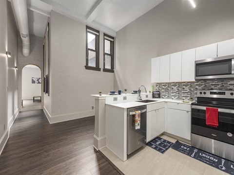 a kitchen with an island and a stove and a microwave