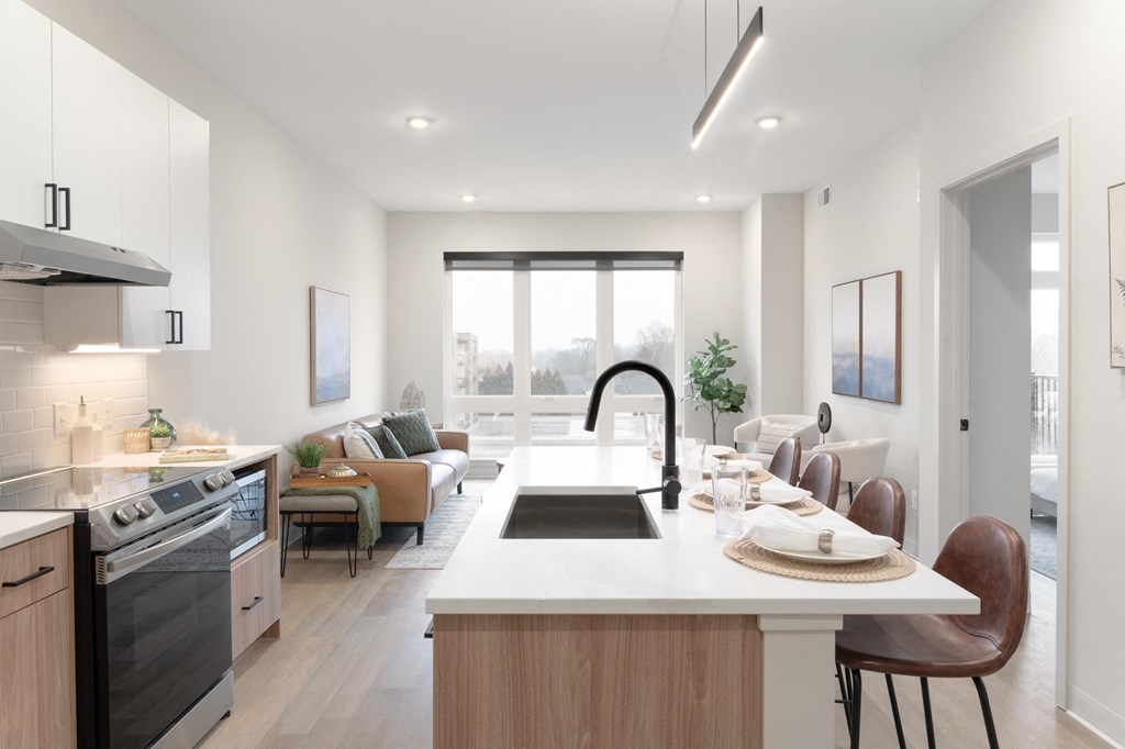 an open kitchen and living room with a large counter and a sink in Rocky River, OH 44116