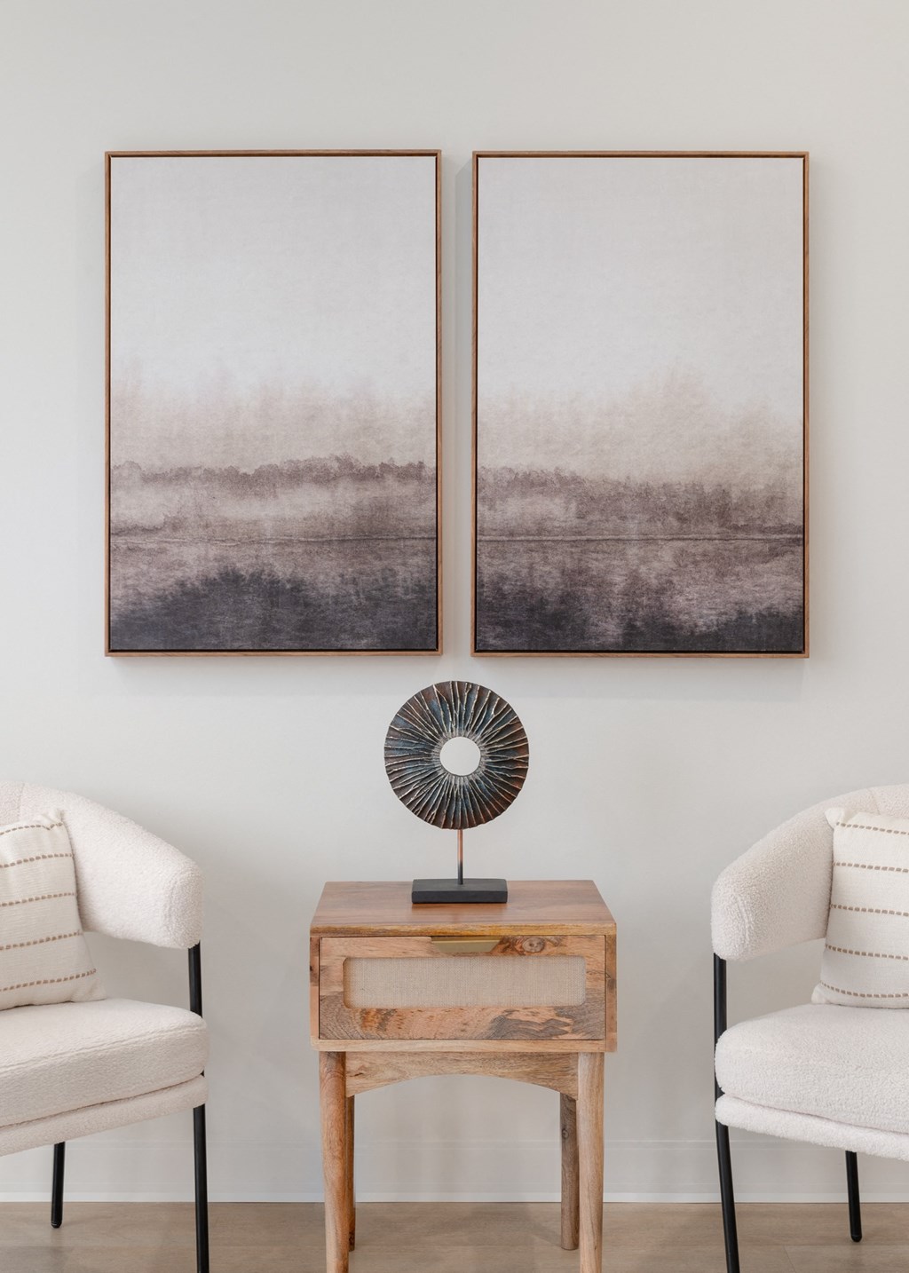 two paintings hanging in a living room with two chairs and a table in Rocky River, OH 44116