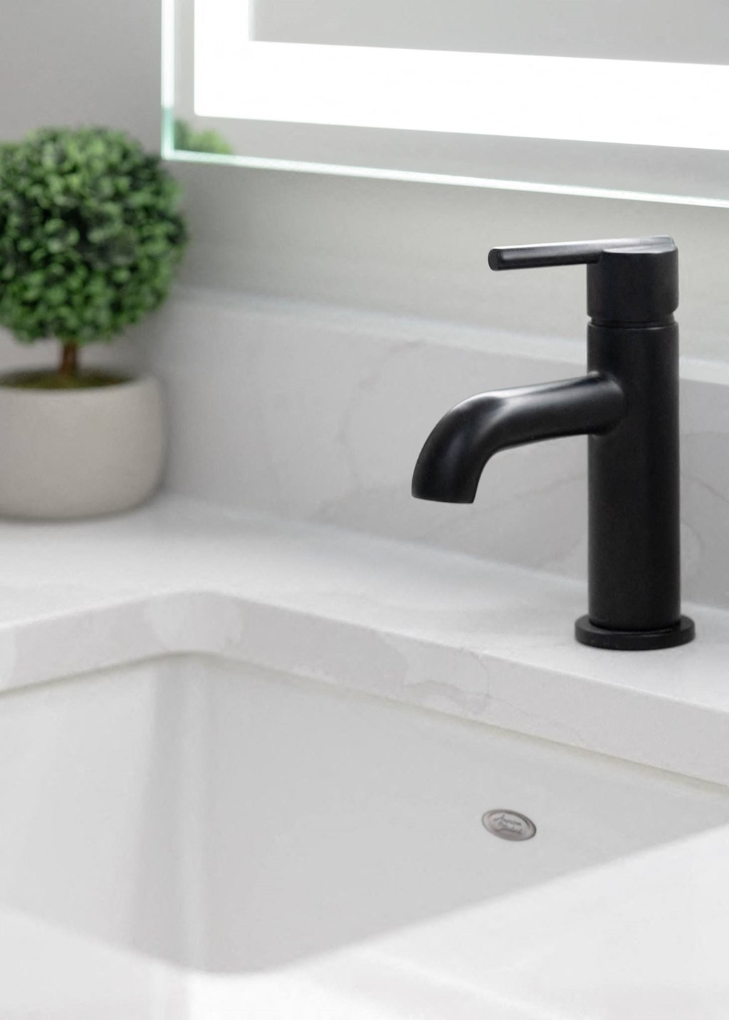 a white sink with a black faucet in a bathroom in Rocky River, OH 44116