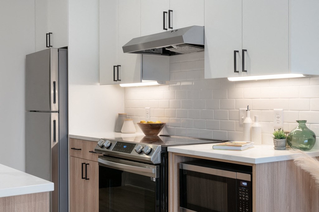 a kitchen with stainless steel appliances and white cabinets in Rocky River, OH 44116
