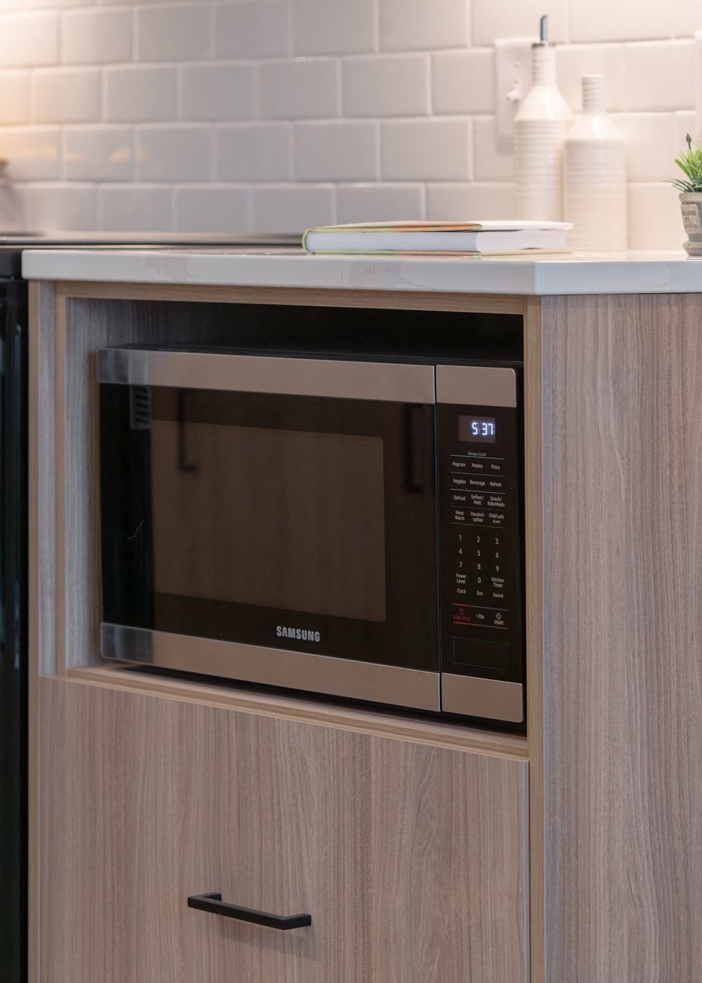 a microwave oven sitting on top of a wooden cabinet in Rocky River, OH 44116