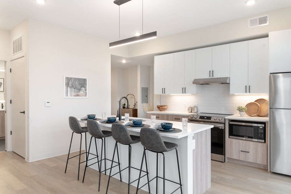 a kitchen with a large island with bar stools in Rocky River, OH 44116