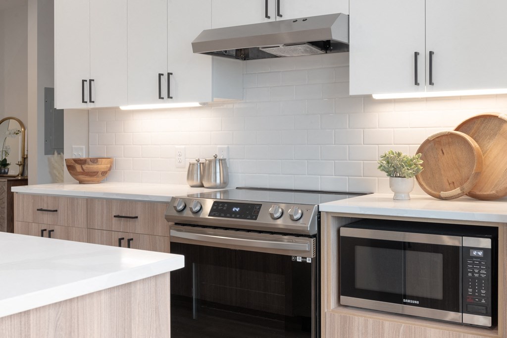 a kitchen with white cabinets and black appliances and white counter tops in Rocky River, OH 44116