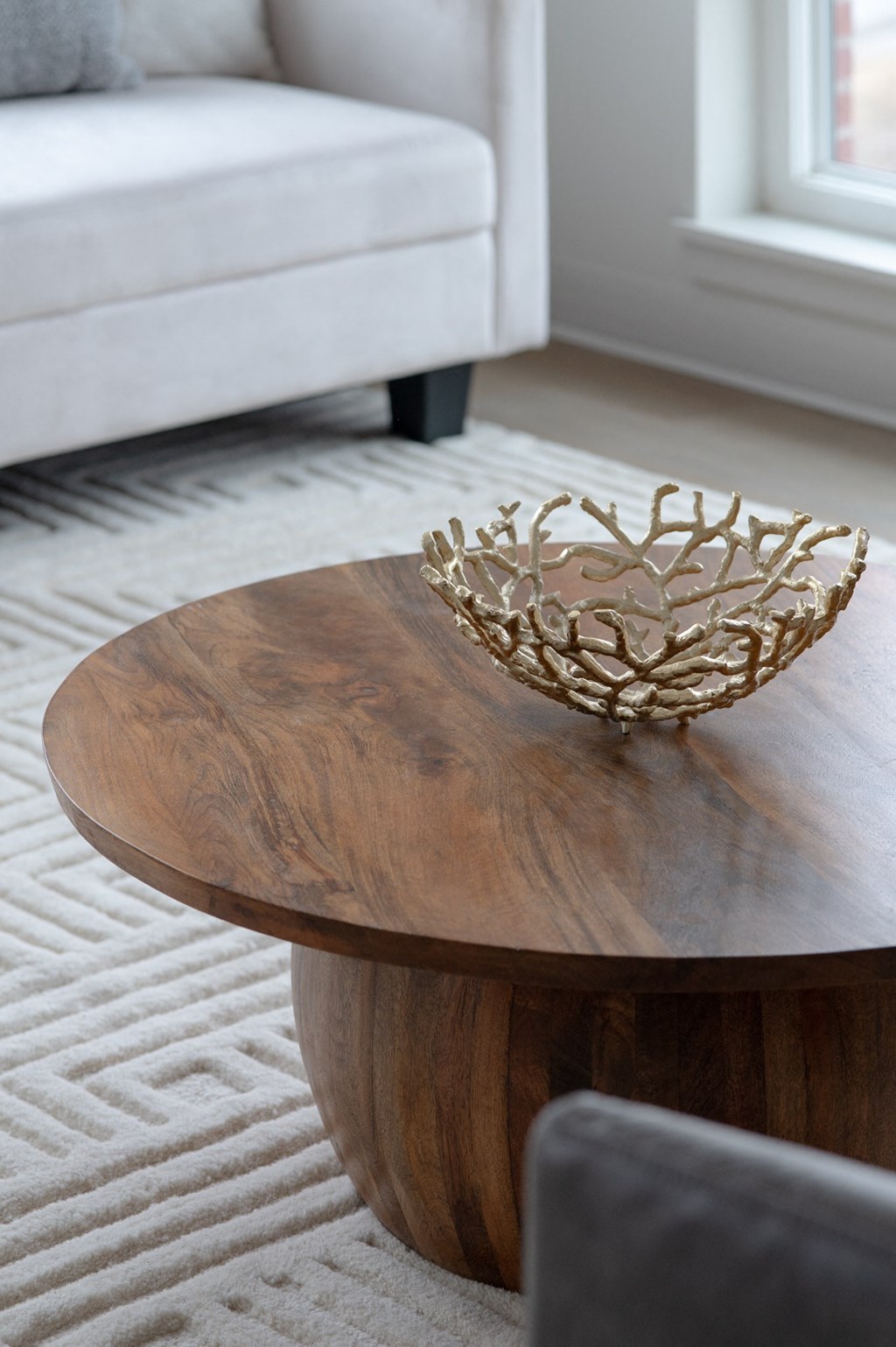 a living room with a wooden coffee table and a white couch in Rocky River, OH 44116