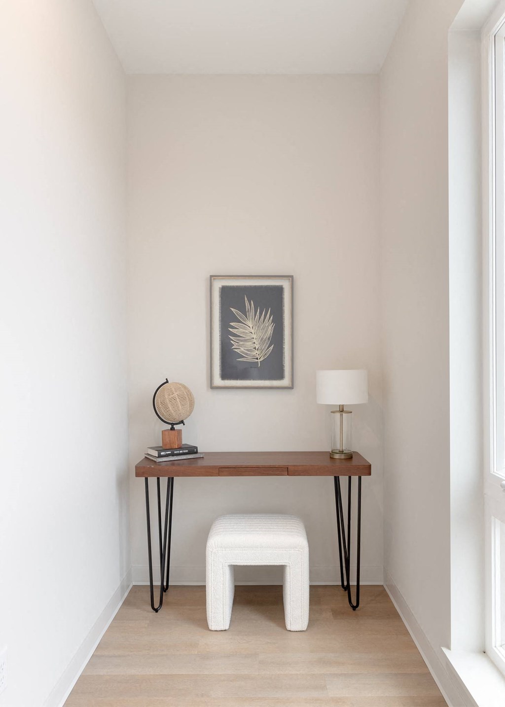 a small desk with a stool in a room with white walls in Rocky River, OH 44116