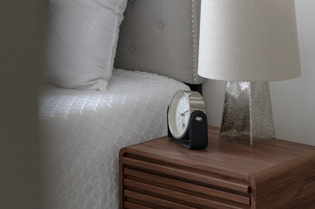 a clock on a night stand next to a bed in Rocky River, OH 44116