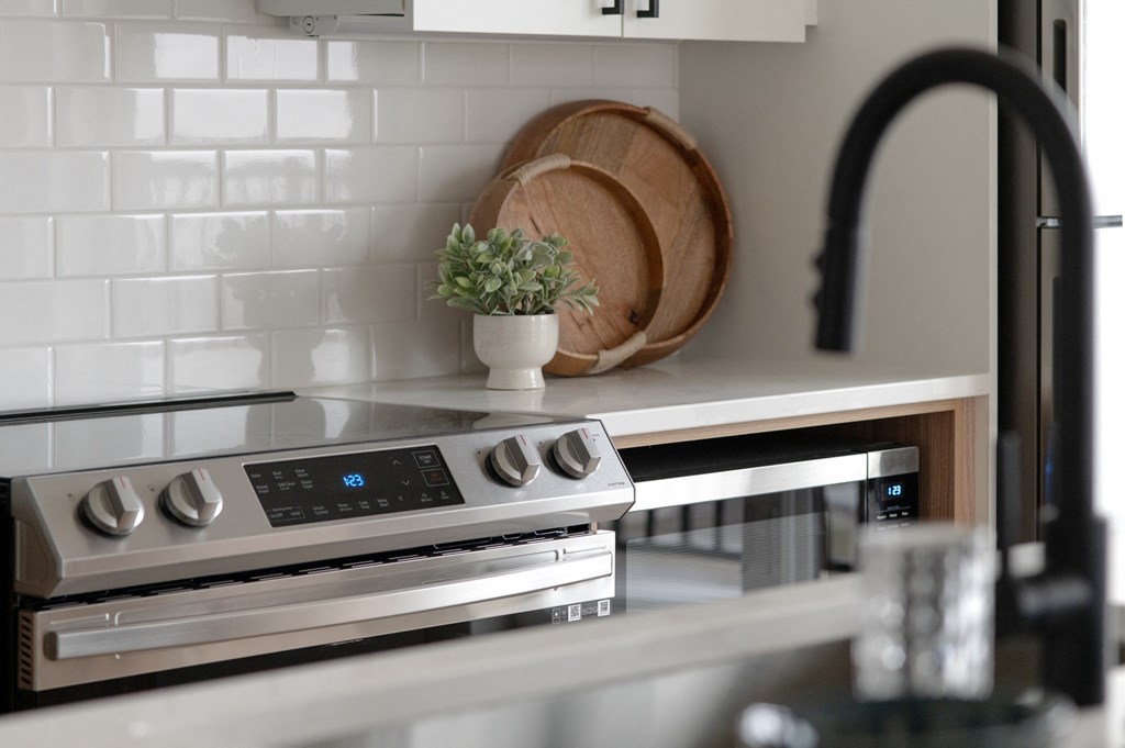 a white kitchen with a stove and a sink in Rocky River, OH 44116