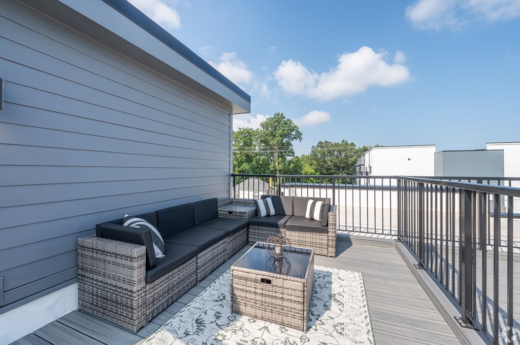 A patio with a couch and a table. at Park Lamont Townhomes Apartments, Ohio, 44106
