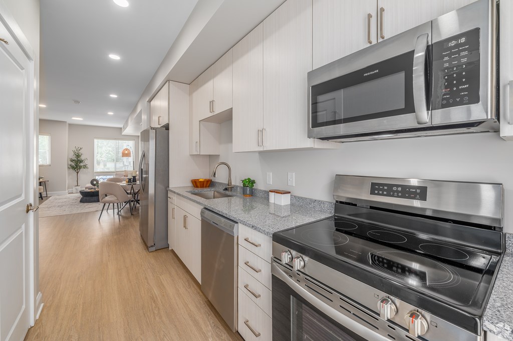 A modern kitchen with a stainless steel oven and microwave. at Park Lamont Townhomes Apartments, Cleveland, OH
