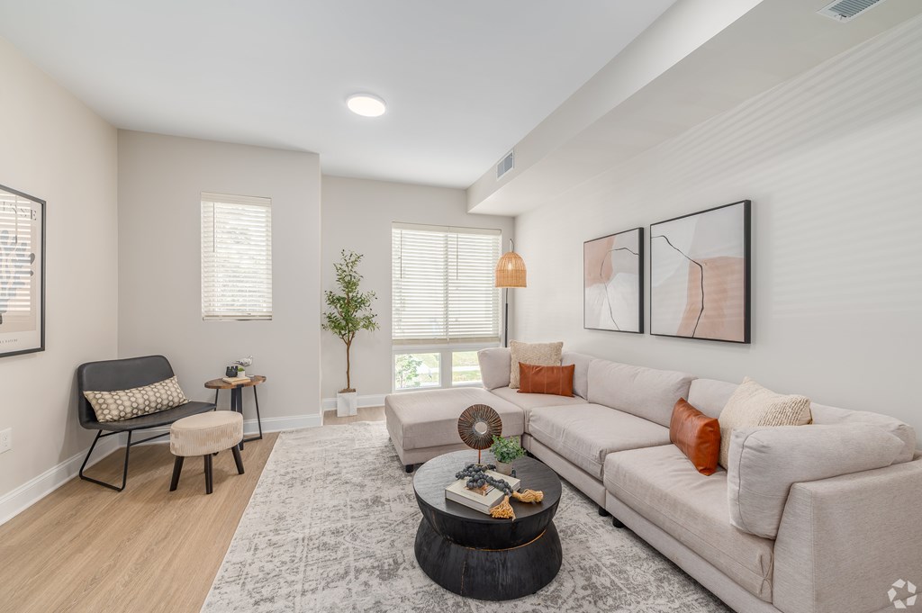 A living room with a couch, chair, and coffee table. at Park Lamont Townhomes Apartments, Cleveland, OH