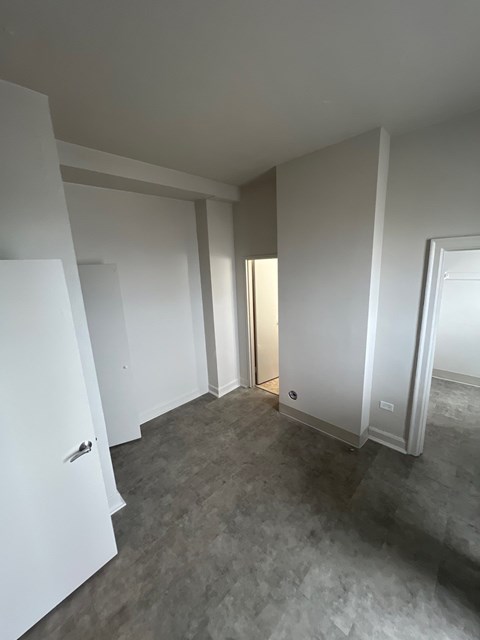 A room with a grey floor and white walls.