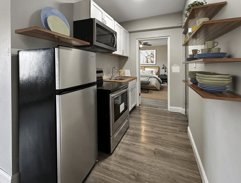 a kitchen with a refrigerator and a microwave