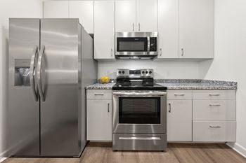 A modern kitchen with a stainless steel refrigerator and oven. at The Lumos Apartments, Cleveland