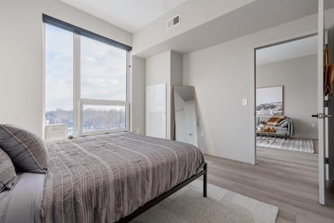 Queen bed with Cleveland city views at TREO Apartments, Cleveland