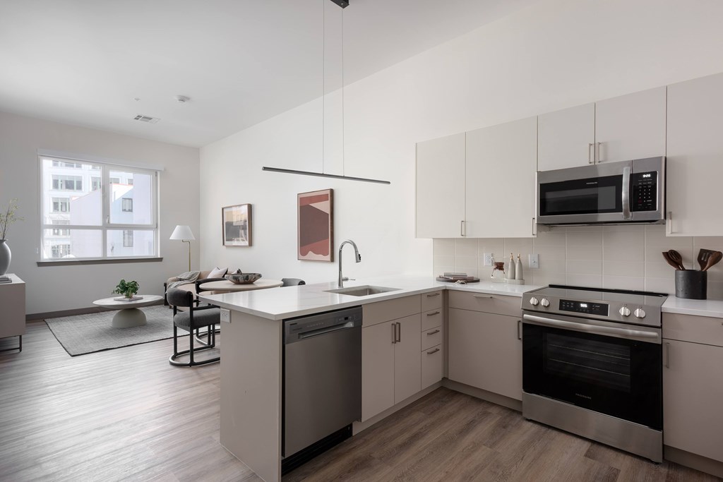A modern kitchen with a large island and stainless steel appliances.