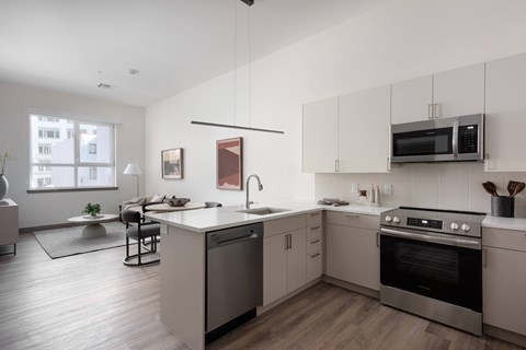 A modern kitchen with a large island and stainless steel appliances.