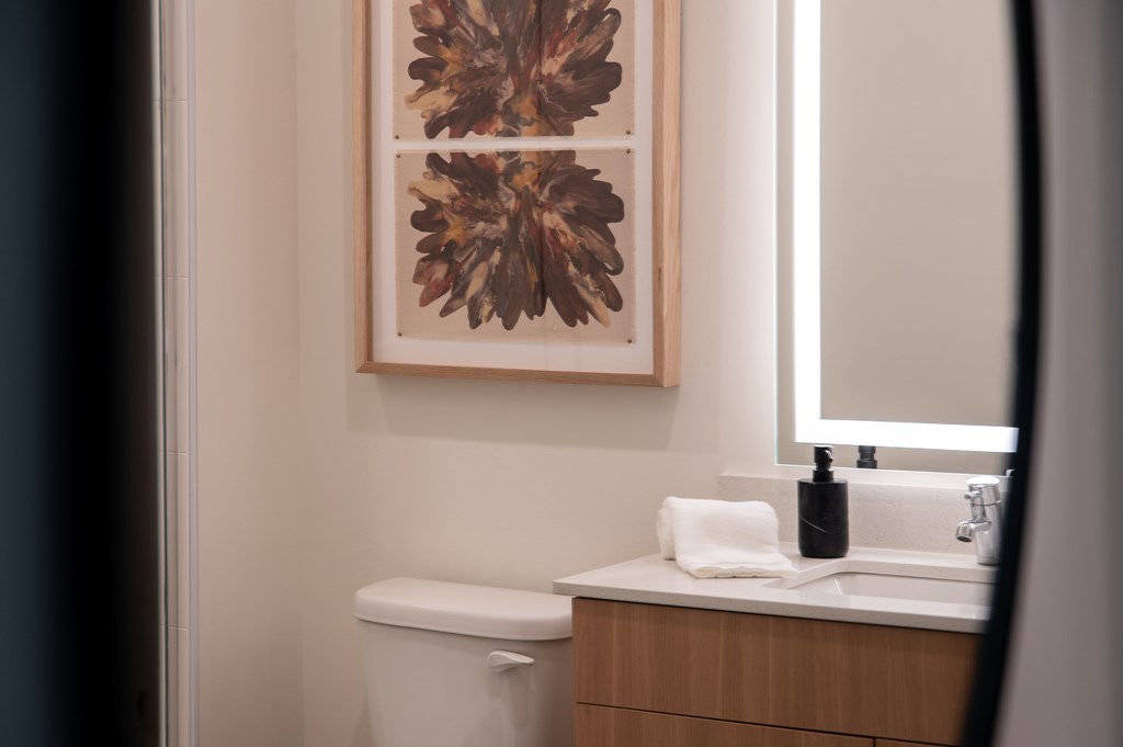 A white toilet sits next to a sink in a bathroom.