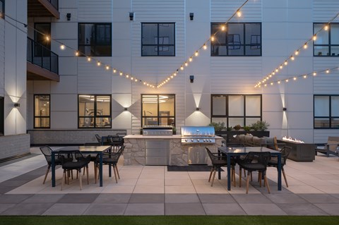 A patio with a table and chairs is set up outside a building.
